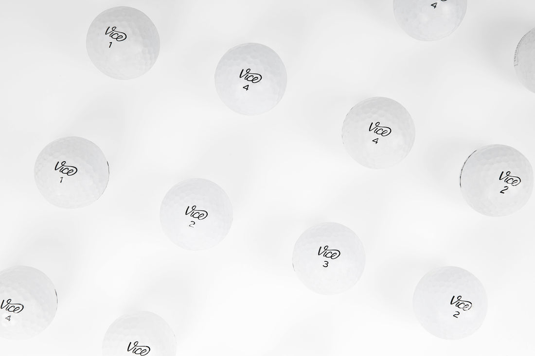 Vice golf balls on a white backdrop