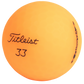 Orange golf ball with 'Titleist' branding on a white background