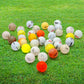 a bunch of shag golf balls on green grass