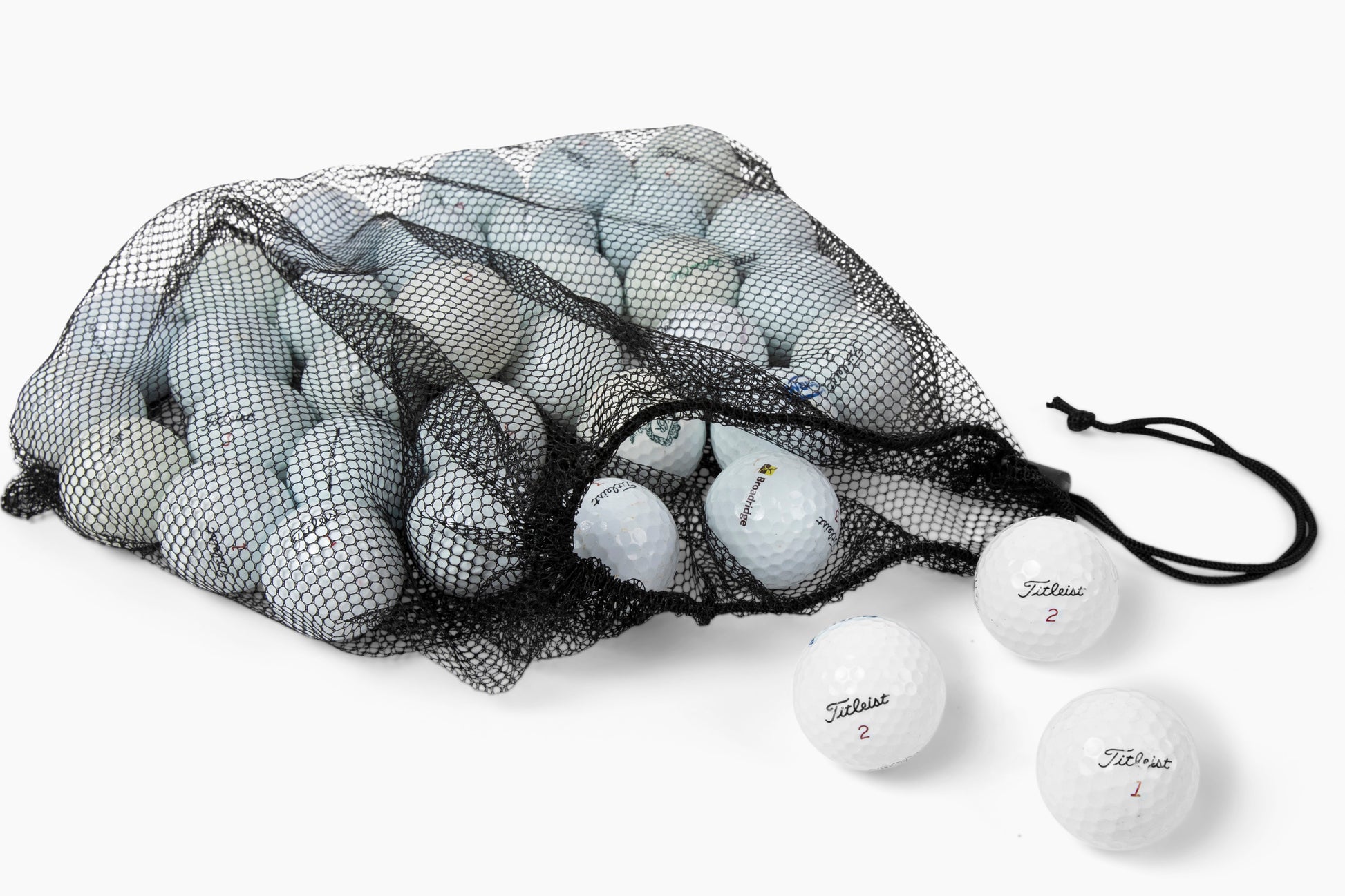 titleist nxt golf balls coming out of mesh bag