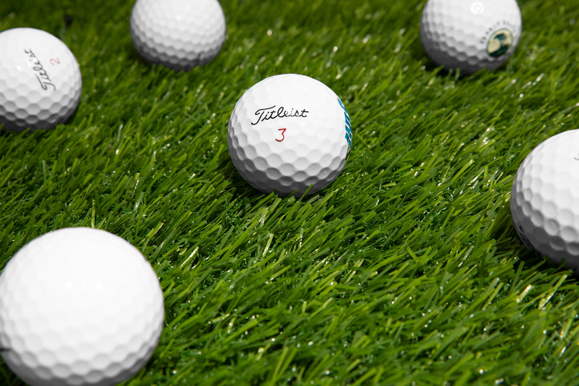 titleist nxt golf balls on green grass